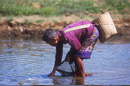 Old woman collecting river moss, Vang Vieng, VIENTIANE
